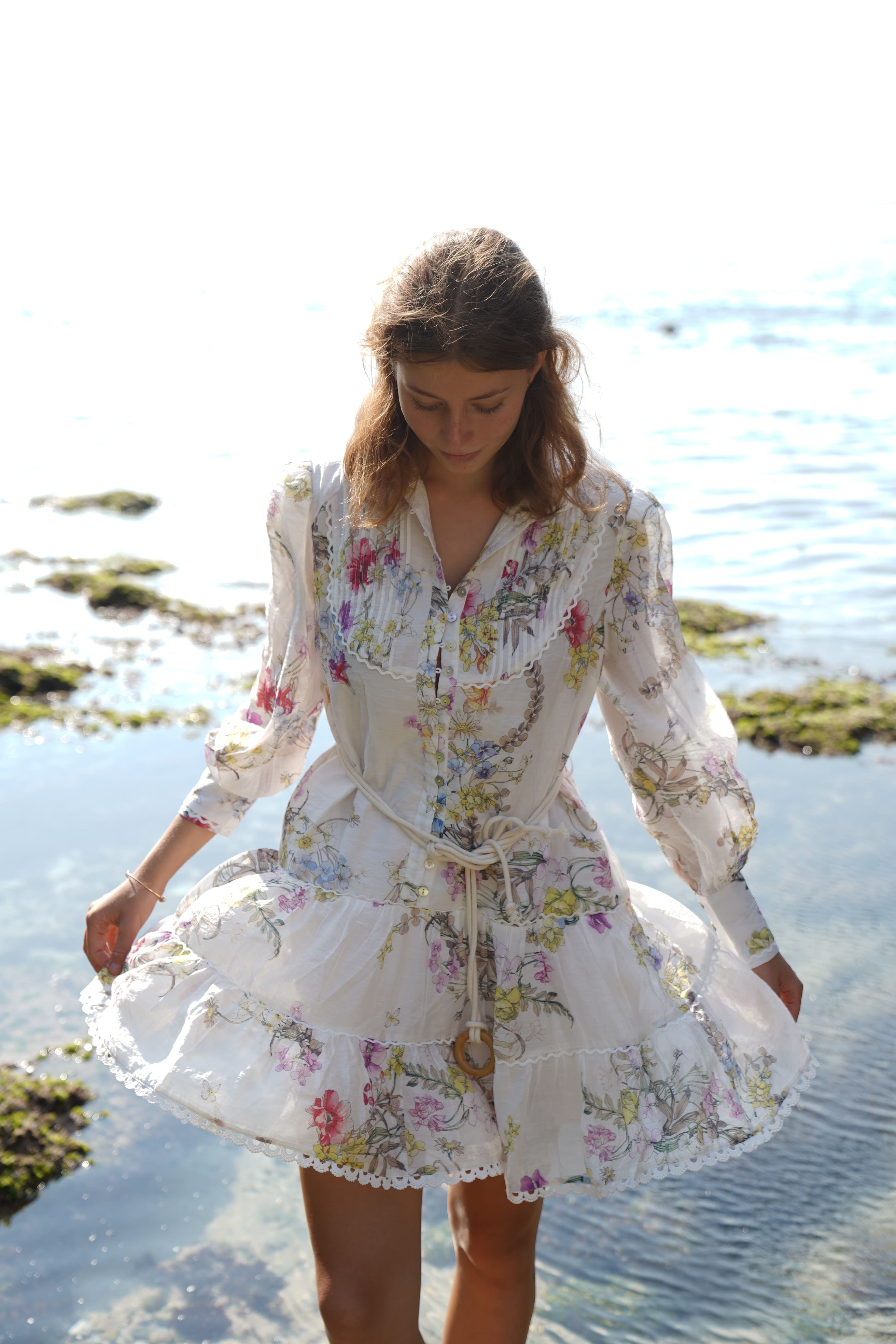 white mini dress with ruffle tiered skirt, pleated bodice, wildflower print